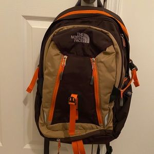The Northface pack. Orange, brown, camel.